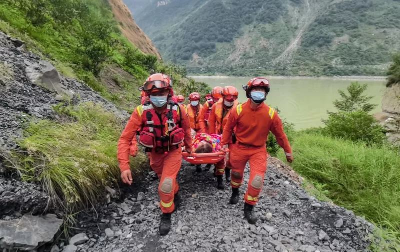 Rescue workers carry an injured person after a 6.6-magnitude earthquake in Luding county, Ganzi Prefecture in China's southwestern Sichuan province on September 6, 2022. (Photo by CNS / AFP) / China OUT