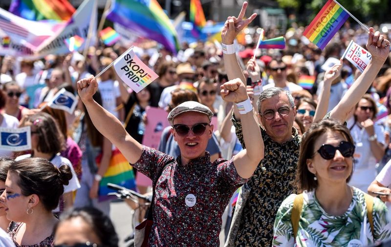 Participants gesture as they wave flags during the "Skopje Pride" march in downtown Skopje, on June 29, 2019, as North Macedonia is holding its first ever pride parade. (Photo by Robert ATANASOVSKI / AFP)