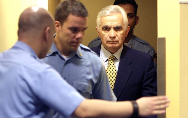 The former speaker of the Bosnian Serb Parliament, Momcilo Krajisnik, enters the courtroom of the  UN's Yugoslav war crimes court for his appeal verdict in the Hague, Netherlands, on March 17, 2009. The International Criminal Tribunal for the former Yugoslavia (ICTY) cut seven years off the 27-year sentence of Krajisnik, as it reversed some of his convictions for crimes against humanity. AFP PHOTO / BAS CZERWINSKI 
- netherlands out - belgium out - (Photo by BAS CZERWINSKI / POOL / AFP)