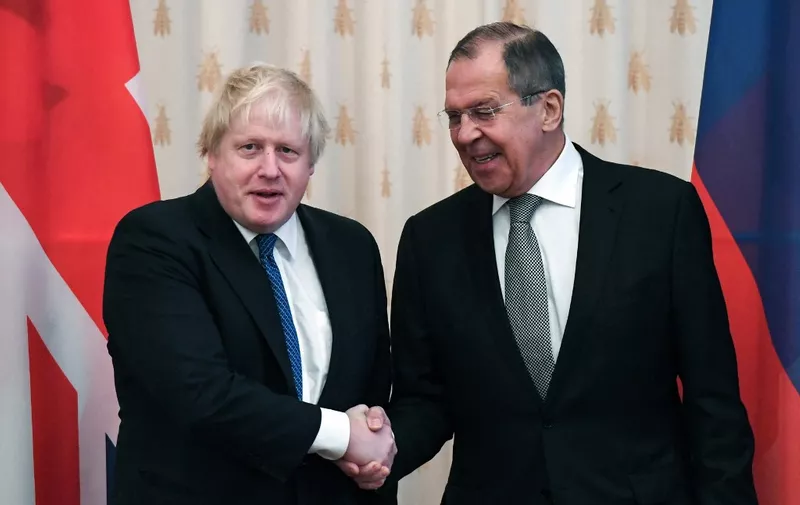 Russian Foreign Minister Sergei Lavrov (R) shakes hands with British Foreign Secretary Boris Johnson during a meeting in Moscow on December 22, 2017. (Photo by Yuri KADOBNOV / AFP)