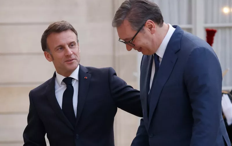 France's President Emmanuel Macron (L) welcomes Serbia's President Aleksandar Vucic upon his arrival at the presidential Elysee Palace in Paris on April 8, 2024. The two heads of state are expected to discuss issues including Serbia's European integration and relations between Belgrade and Kosovo. (Photo by Ludovic MARIN / AFP)