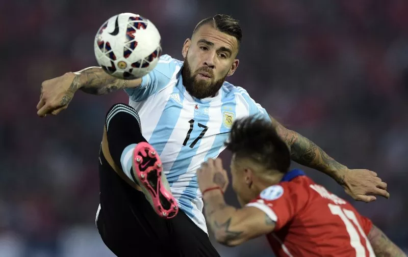 Chile's forward Eduardo Vargas (R) vies for the ball with Argentina's defender Nicolas Otamendi during their 2015 Copa America final football match, in Santiago, Chile, on July 4, 2015. AFP PHOTO / JUAN MABROMATA