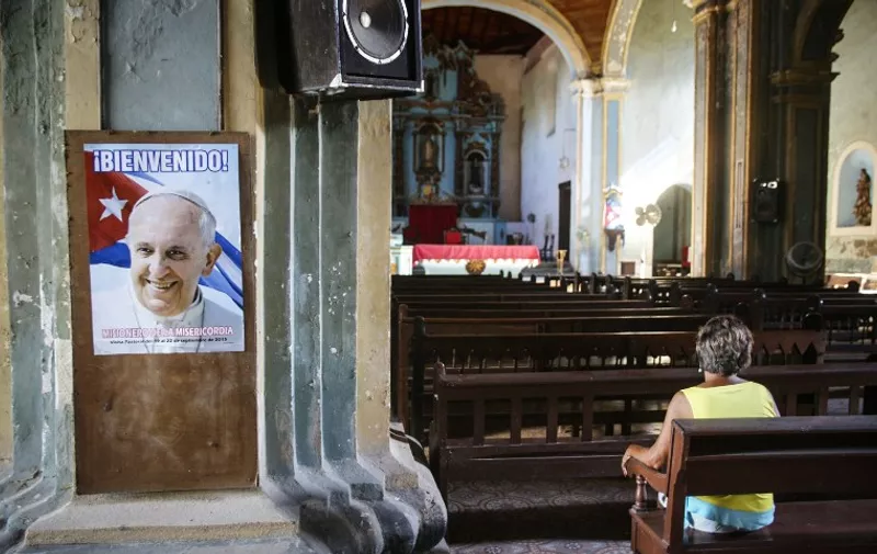 View of a poster of Pope Francis at a church in Santiago de Cuba province, Cuba on September 7, 2015. Pope Francis will visit Cuba from September 19 to 22 as part of a tour that will later take him to the United States. AFP PHOTO/STR
