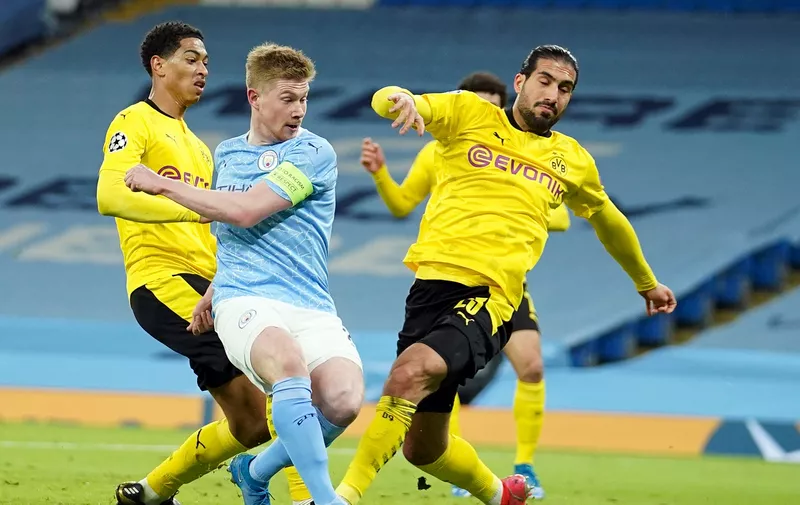 Manchester City's Kevin De Bruyne, center, scores his side's first goal, during the Champions League, first leg, quarterfinal soccer match between Manchester City and Borussia Dortmund at the Etihad stadium in Manchester, Tuesday, April 6, 2021. (AP Photo/Dave Thompson)