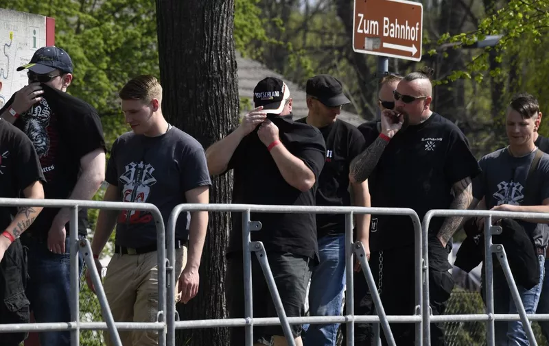Participants queue up to enter the Neisseblick Hotel where the "Schild und Schwert" (Shield and Sword) neo-Nazi festival is taking place, in the small eastern German town of Ostritz on April 21, 2018. - Hundreds of neo-Nazis congregated on April 20, 2018, which marks Adolf Hitler's birthday, and April 21, 2018 for a two-day festival in Ostritz, where anti-fascist groups have vowed counter-protests. (Photo by John MACDOUGALL / AFP)