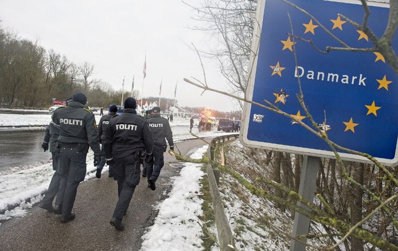 (FILES) This file photo taken on January 09, 2016 shows Danish
police officers walking at the Danish-German border on January 9, 2016 in Krusaa, Denmark.  
A controversial bill is due to be discussed in the Danish parliament on Wednesday, January 13, 2016, which would allow police to seize migrants' valuables to pay for their stay in asylum centres. / AFP / Scanpix Denmark / Claus Fisker