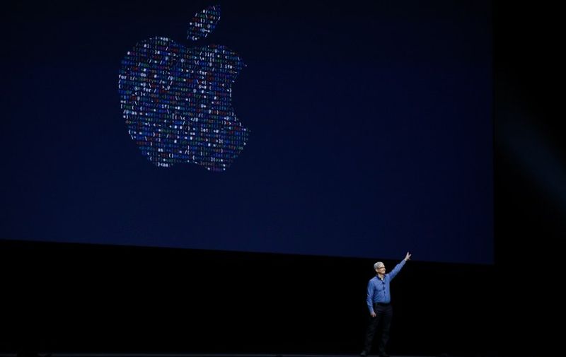 Apple CEO Tim Cook waves after delivering the keynote address at Apple's annual Worldwide Developers Conference at the Bill Graham Civic Auditorium in San Francisco, California, onJune 13, 2016. / AFP PHOTO / GABRIELLE LURIE