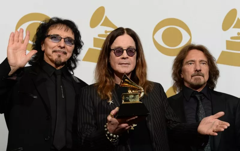 (FILES) In this January 26, 2014 file photo, Tony Iommi (L), Ozzy Osbourne (C) and Geezer Butler (R) of Black Sabbath pose in the press room after winning Best Metal Performance for 'God is Dead?' during the 56th Grammy Awards at the Staples Center in Los Angeles, California.  Heavy metal pioneers Black Sabbath on October 27, 2015 announced a slew of new concerts as the band extended a 2016 tour that it insists will be its last. Ozzy Osbourne's band, previously scheduled to call it quits in April in New Zealand, will play across Europe and North America throughout the summer. The final concert is now scheduled to take place on September 21 in Phoenix, Arizona. The tour -- dubbed "The End" -- opens on January 20 elsewhere in the United States, in Omaha. AFP PHOTO / JOE KLAMAR