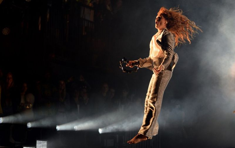 Florence Welch from British band Florence and the Machine performs on the Pyramid Stage on the first official date of the Glastonbury Festival of Music and Performing Arts on Worthy Farm near the village of Pilton in Somerset, south west England, on June 26, 2015.   AFP PHOTO / OLI SCARFF