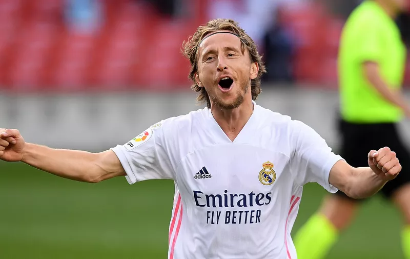 BARCELONA, SPAIN - OCTOBER 24: Luka Modric of Real Madrid  celebrates after scoring his team's third goal  during the La Liga Santander match between FC Barcelona and Real Madrid at Camp Nou on October 24, 2020 in Barcelona, Spain. Sporting stadiums around Spain remain under strict restrictions due to the Coronavirus Pandemic as Government social distancing laws prohibit fans inside venues resulting in games being played behind closed doors. (Photo by Alex Caparros/Getty Images)