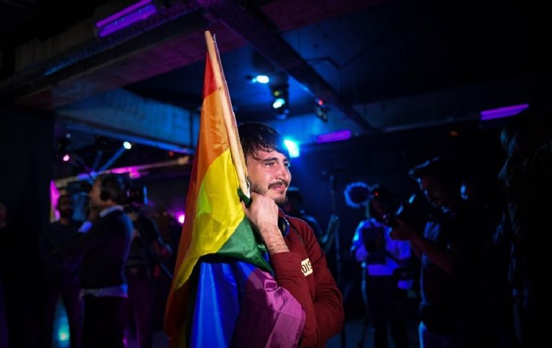 A member of the LGBT community goes emotional in a club as community members wait for the results of a referendum in Bucharest, Romania on October 7, 2018. 
Romanians vote on Saturday and Sunday to choose if they agree or not with the proposal to change the Constitution so it stipulates that marriage is between a man and a woman, not simply "spouses", as it currently states. From a legal stance nothing will change, no matter the outcome of the vote, for the Romanian law doesn't allow same-sex marriage. But critics of the initiative say an explicit definition of what constitutes a family would make it almost impossible to change the law in favour of same-sex couples.  / AFP PHOTO / Daniel MIHAILESCU