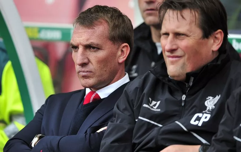 Liverpool's Northern Irish manager Brendan Rodgers (L) looks on during the English Premier League football match between Stoke City and Liverpool at the Britannia Stadium in Stoke-on-Trent, central England on May 24, 2015. Stoke won the game 6-1. AFP PHOTO / STEVE PARKIN

RESTRICTED TO EDITORIAL USE. NO USE WITH UNAUTHORIZED AUDIO, VIDEO, DATA, FIXTURE LISTS, CLUB/LEAGUE LOGOS OR LIVE SERVICES. ONLINE IN-MATCH USE LIMITED TO 45 IMAGES, NO VIDEO EMULATION. NO USE IN BETTING, GAMES OR SINGLE CLUB/LEAGUE/PLAYER PUBLICATIONS.