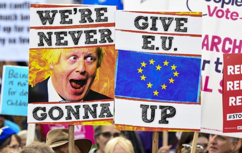 Demonstrators hold placards and EU and Union flags as they take part in a march by the People's Vote organisation in central London on October 19, 2019, calling for a final say in a second referendum on Brexit. - Thousands of people march to parliament calling for a "People's Vote", with an option to reverse Brexit as MPs hold a debate on Prime Minister Boris Johnson's Brexit deal. (Photo by Niklas HALLE'N / AFP)