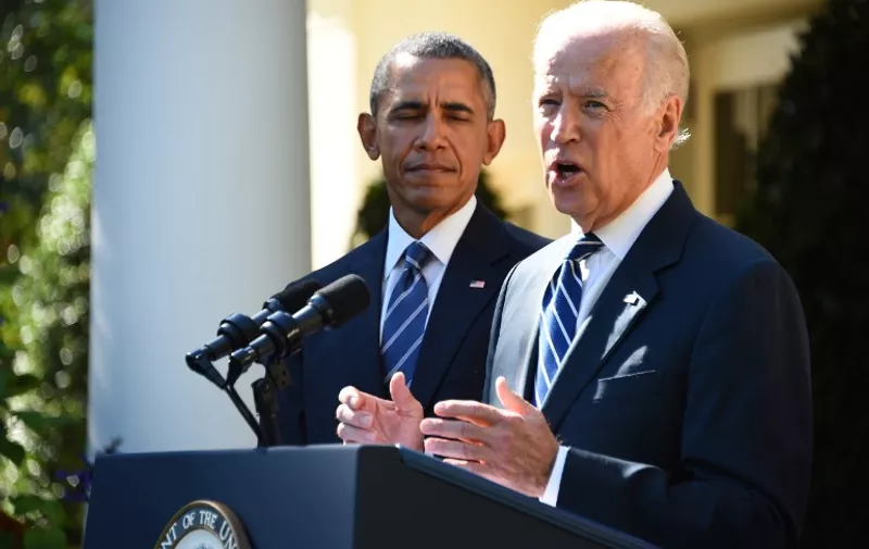 US Vice President Joe Biden (R), flanked by US President Barack Obama , speaks in the Rose Garden at the White House on October 21, 2015, in Washington, DC. Biden announced that he is not running for president. AFP PHOTO / JIM WATSON