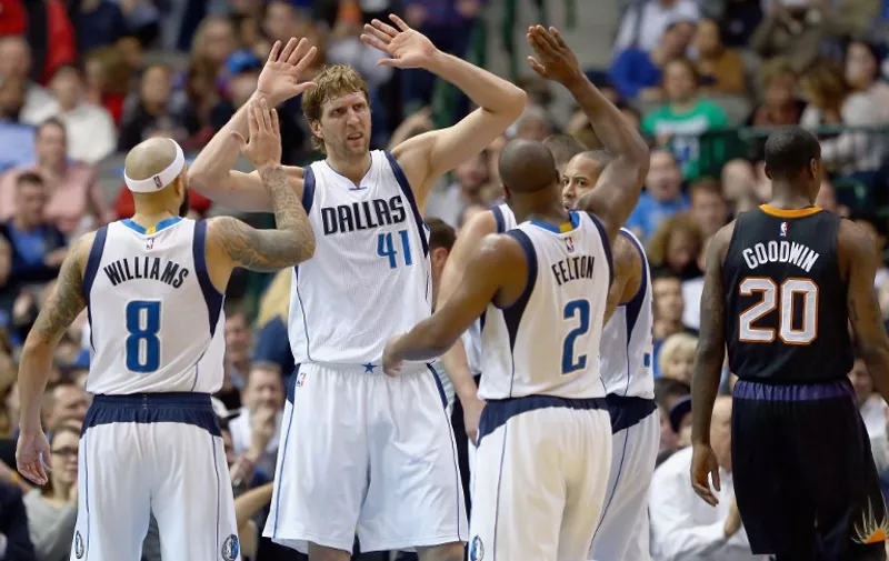 DALLAS, TX - DECEMBER 14: Dirk Nowitzki #41 of the Dallas Mavericks celebrates with Deron Williams #8 of the Dallas Mavericks and Raymond Felton #2 of the Dallas Mavericks in the second half against the Phoenix Suns at American Airlines Center on December 14, 2015 in Dallas, Texas. NOTE TO USER: User expressly acknowledges and agrees that, by downloading and or using this photograph, User is consenting to the terms and conditions of the Getty Images License Agreement.   Tom Pennington/Getty Images/AFP