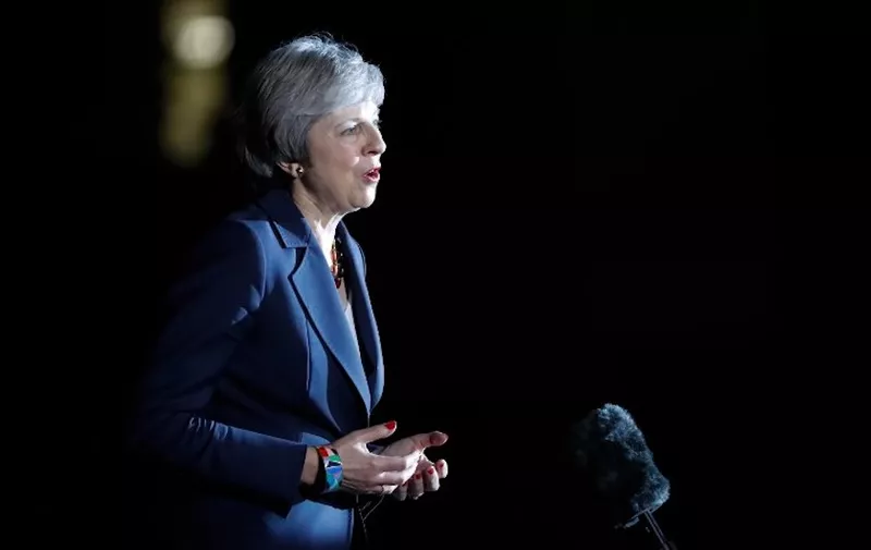 Britain's Prime Minister Theresa May gives a statement outside 10 Downing Street in London on November 14, 2018, after holding a cabinet meeting where ministers were expected to either back the draft bexit deal or quit. - British Prime Minister Theresa May defended her anguished draft divorce deal with the European Union on Wednesday before rowdy lawmakers and a splintered cabinet that threatens to fall apart. (Photo by Tolga AKMEN / AFP)