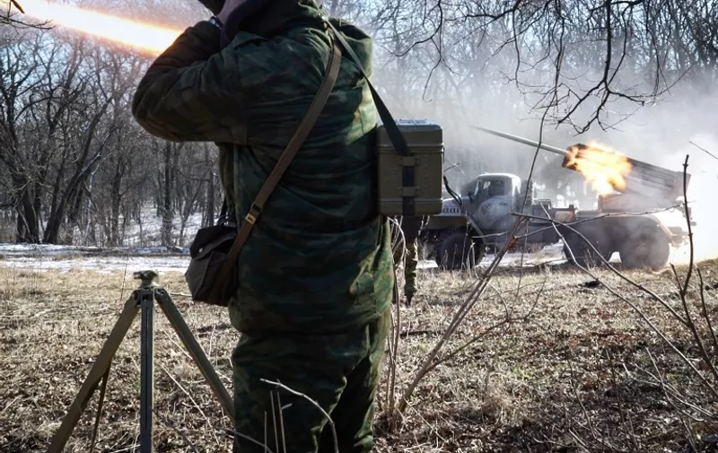 Pro-Russian rebels stationed in the eastern Ukrainian city of Gorlivka, Donetsk region, launch missiles from a Grad launch vehicle toward a position of the Ukrainian forces  in Debaltseve, about 35km east of Gorlivka, on February 13, 2015. Fighting raged in Ukraine today as the clock ticked down to a ceasefire that will be a first test of Kiev and pro-Russian separatists' committment to a freshly-inked peace plan. AFP PHOTO / ANDREY BORODULIN / AFP / ANDREY BORODULIN