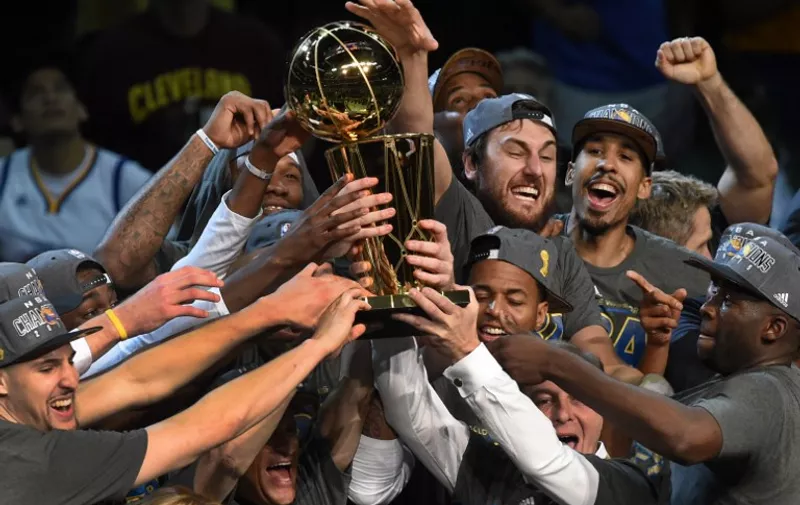 The Golden State Warriors celebrate winning the 2015 NBA Finals on June 16, 2015 at the Quicken Loans Arena in Cleveland, Ohio.  Steph Curry and Andre Iguodala each scored 25 points as the Golden State Warriors captured their first NBA title in 40 years by defeating Cleveland 105-97 to win the NBA Finals.  AFP PHOTO  / TIMOTHY A. CLARY