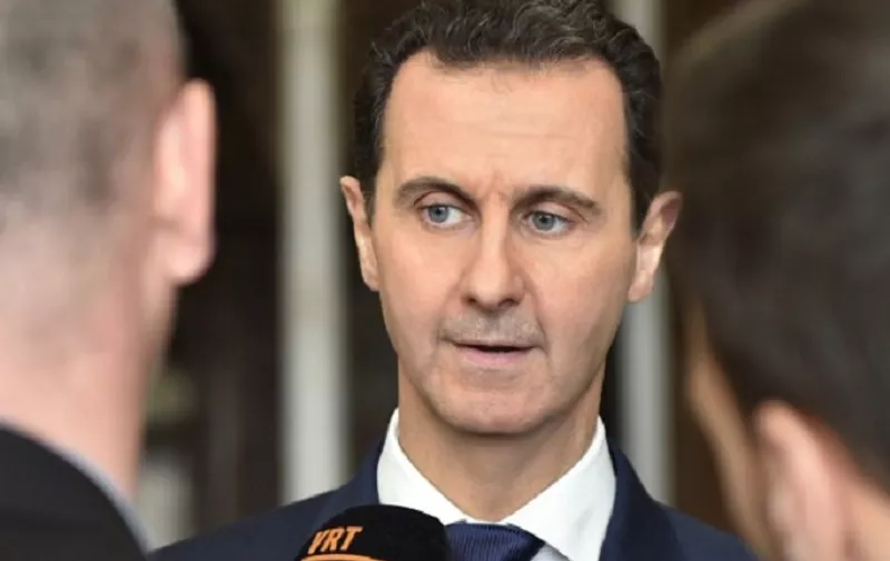 A handout picture released by the official Syrian Arab News Agency (SANA) on February 7, 2017 shows Syrian President Bashar al-Assad giving an interview to a Belgian media outlet.    / AFP PHOTO / SANA / -