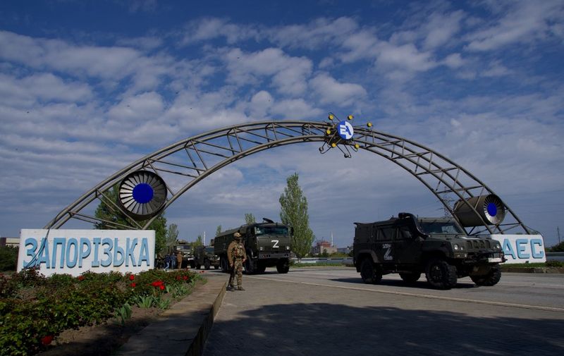 (FILES) In this file photo taken on May 1, 2022, Russian military vehicles drive through the gates of the Zaporizhzhia Nuclear Power Station in Energodar. - Kyiv on August 8, 2022, called for the establishment of a demilitarised zone around the nuclear power station in east Ukraine, where recent fighting with Russian forces has raised fears of a nuclear accident. The Kremlin on August 8, 2022, accused Ukrainian forces of firing on the Zaporizhzhia atomic power plant, warning of potential "catastrophic consequences" for Europe.
 *EDITOR'S NOTE: This picture was taken during a media trip organised by the Russian army.* (Photo by Andrey BORODULIN / AFP)