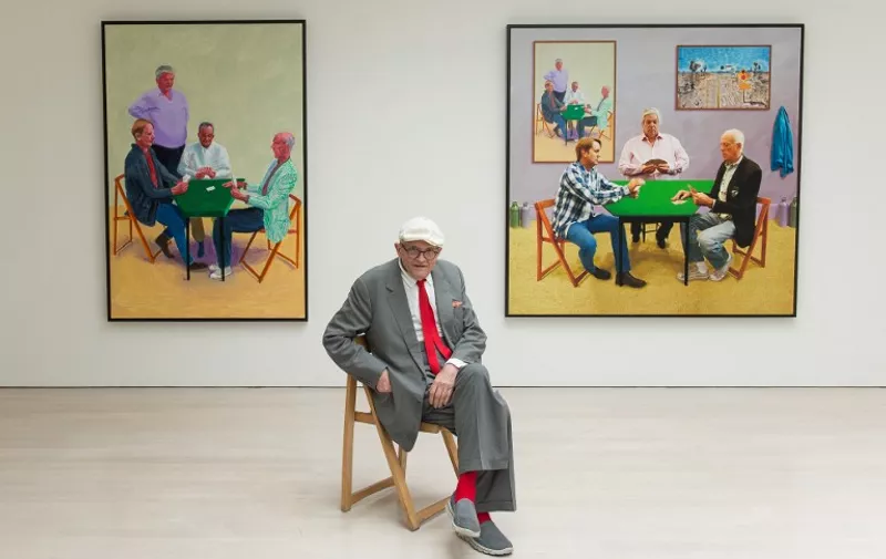 Artist David Hockney poses with his artworks "Card Players #3 2014" (L) and "A Bigger Card Players 2015" at a press preview of his new exhibition entitled "Painting and Photography" in central London, on May 14, 2015. The exhibition, on display at the Annely Juda gallery, runs from May 15 to June 27, 2015.   AFP PHOTO / LEON NEAL

 RESTRICTED TO EDITORIAL USE, MANDATORY MENTION OF THE ARTIST UPON PUBLICATION, TO ILLUSTRATE THE EVENT AS SPECIFIED IN THE CAPTION  / AFP / LEON NEAL