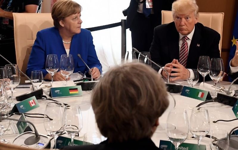German Chancellor Angela Merkel (L) and US President Donald Trump attend a working lunch during the Summit of the Heads of State and of Government of the G7, the group of most industrialized economies, plus the European Union, on May 26, 2017 in Taormina, Sicily.
The leaders of Britain, Canada, France, Germany, Japan, the US and Italy will be joined by representatives of the European Union and the International Monetary Fund (IMF) as well as teams from Ethiopia, Kenya, Niger, Nigeria and Tunisia during the summit from May 26 to 27, 2017. / AFP PHOTO / Justin TALLIS / ALTERNATIVE CROP