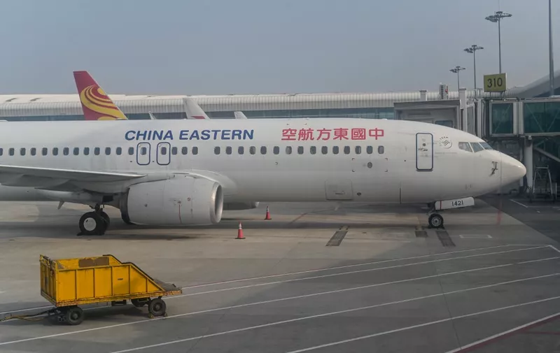 (FILES) This file photo taken on February 12, 2021 shows a China Eastern Airlines Boeing 737-800 aircraft parked at Tianhe International Airport in Wuhan, China's central Hubei province. - A China Eastern passenger jet carrying at least 132 people has "crashed" in southwest China, the state flight regulator confirmed on March 21, 2022, with the number of casualties unknown according to the country's state broadcaster. (Photo by Hector RETAMAL / AFP)