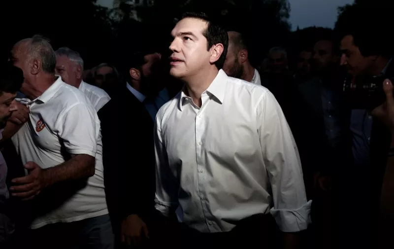 Greek Prime Minister Alexist Tsipras looks on as he walks to Syntagma Square in Athens to give a speech to his supporters on July 3, 2015. Tsipras urged voters to ignore European scaremongering and vote 'No' for Sunday's referendum as polls showed support swinging behind the 'Yes' campaign. AFP PHOTO / ANGELOS TZORTZINIS