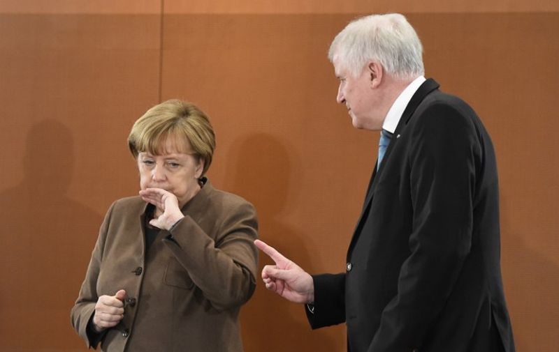 German Chancellor Angela Merkel chats with party leader of the Christian Social Union Party (CSU) and Bavarian State Premier Horst Seehofer before a meeting with the leaders of Germany's Federal States in Berlin December 3, 2015. AFP PHOTO / TOBIAS SCHWARZ / AFP / TOBIAS SCHWARZ