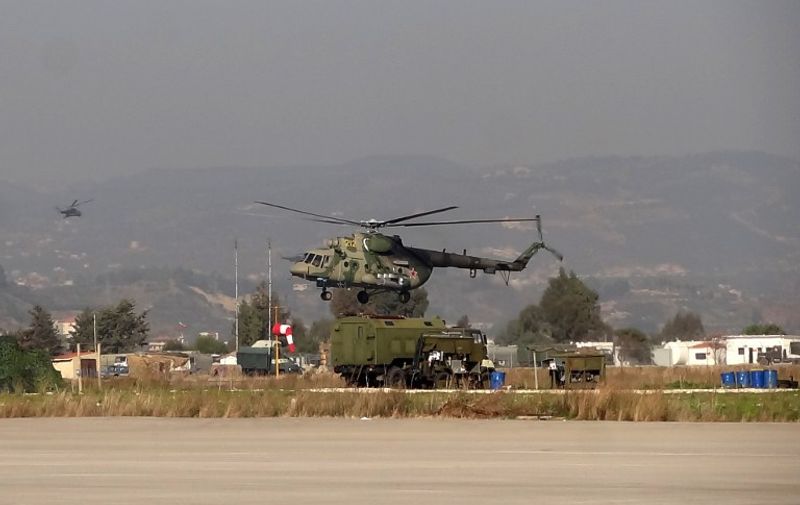 A military helicopter is seen at the Russian Hmeimim military base in Latakia province, in the northwest of Syria, on February 16, 2016. / AFP PHOTO / STRINGER