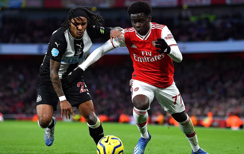 LONDON, ENGLAND - FEBRUARY 16: Bukayo Saka of Arsenal and Valentino Lazaro of Newcastle United during the Premier League match between Arsenal FC and Newcastle United at Emirates Stadium on February 16, 2020 in London, United Kingdom. (Photo by Justin Setterfield/Getty Images)