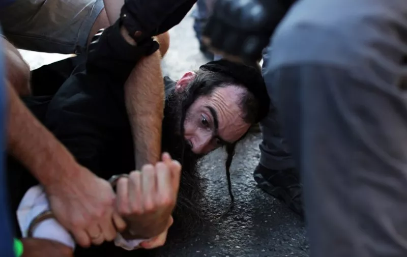 == ISRAEL OUT ==
Yishai Shlissel, an ultra-orthodox Jew, is arrested by Israeli police after he stabbed six people taking part in a Gay Pride march in central Jerusalem on July 30, 2015, seriously wounding two, Israeli police and health services said. Shlissel was released from jail three weeks ago after having served his sentence for a similar attack a decade ago when three marchers were wounded, a police spokesman said. AFP PHOTO / EMIL SALMAN / HAARETZ