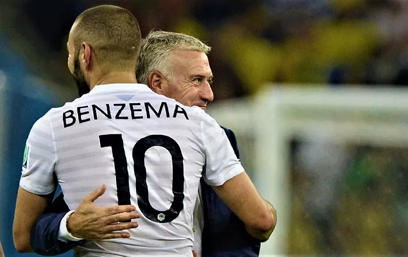 France's coach Didier Deschamps (back) and France's forward Karim Benzema hug  after France drew 0-0 at the end of the Group E football match between Ecuador and France at the Maracana Stadium in Rio de Janeiro during the 2014 FIFA World Cup on June 25, 2014.  AFP PHOTO / FRANCK FIFE (Photo by FRANCK FIFE / AFP)