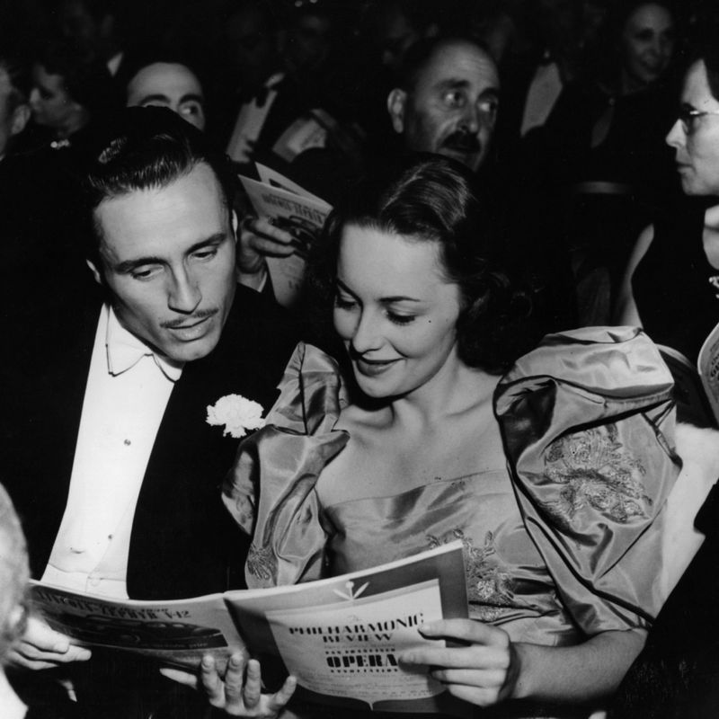 circa 1939:  Hollywood screen star Olivia De Havilland at the opera with American actor Billy Bakewell (1908 - 1993).  (Photo by Hulton Archive/Getty Images)