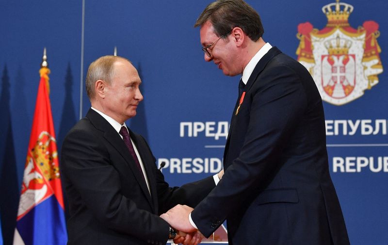 Russian President Vladimir Putin decorates Serbian President Aleksandar Vucic with the Alexander Nevsky Order following a signing ceremony after their talks in Belgrade on January 17, 2019. (Photo by Andrej ISAKOVIC / AFP)