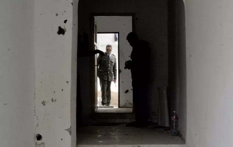 Tunisian police chief inspects a house where two suspected jihadists were killed during a security operation on May 11, 2016 in the town of Mnihla, in Ariana province just outside Tunis. 
Sixteen others, some of them armed, were arrested during the operation, the interior ministry said in a statement. Since its 2011 revolution, Tunisia has faced a growing jihadist threat, with the Islamic State group last year claiming a string of deadly attacks on holidaymakers and security forces that killed dozens.



 / AFP PHOTO / FETHI BELAID
