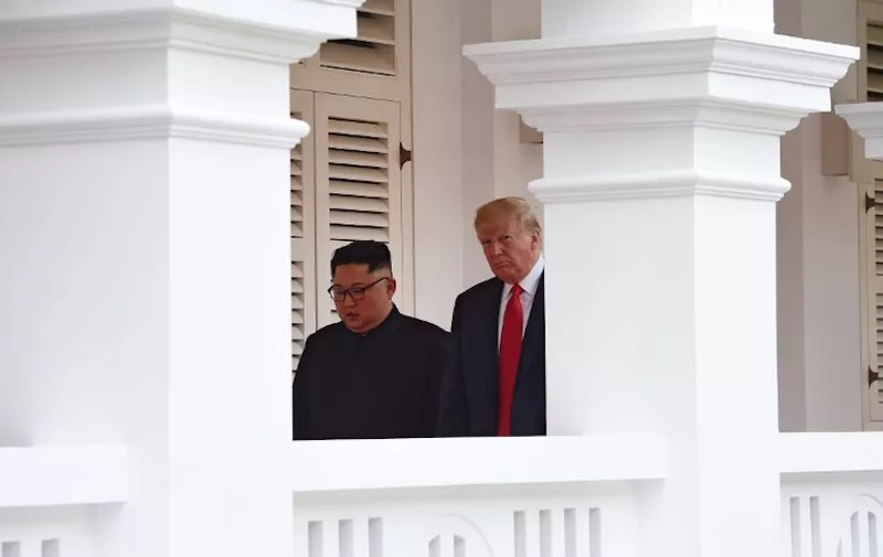 North Korea's leader Kim Jong Un (L) walks out with US President Donald Trump (R) to face the media after taking part in a signing ceremony at the end of their historic US-North Korea summit, at the Capella Hotel on Sentosa island in Singapore on June 12, 2018.
Donald Trump and Kim Jong Un became on June 12 the first sitting US and North Korean leaders to meet, shake hands and negotiate to end a decades-old nuclear stand-off. / AFP PHOTO / POOL / Anthony WALLACE