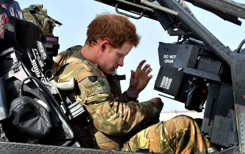 This picture taken on November 2, 2012 shows Britain's Prince Harry sitting in the front seat of his Apache Helicopter at the British controlled flight-line at Camp Bastion in Afghanistan's Helmand Province, where he was serving as an Apache Helicopter Pilot/Gunner with 662 Sqd Army Air Corps. Britain's Prince Harry confirmed he killed Taliban fighters during his stint as a helicopter gunner in Afghanistan, it can be reported after he completed his tour of duty on January 21, 2013.  AFP PHOTO / POOL / JOHN STILLWELL (Photo by JOHN STILLWELL / POOL / AFP)