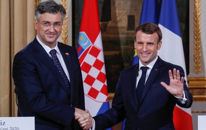French President Emmanuel Macron (R) shakes hands with Croatian Prime Minister Andrej Plenkovic during a press coference in Paris, on January 7, 2020. (Photo by GONZALO FUENTES / POOL / AFP)