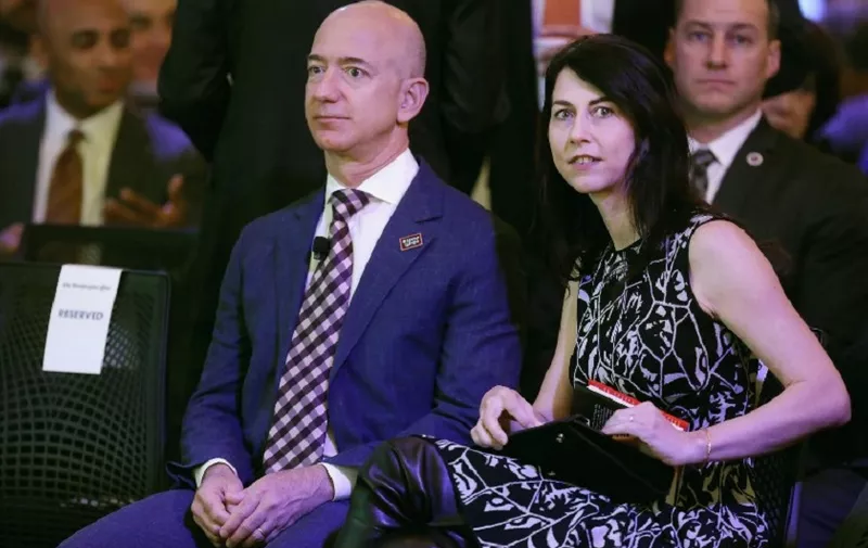 WASHINGTON, DC - JANUARY 28: Amazon founder and Washington Post owner Jeff Bezos and his wife MacKenzie Bezos participate in the opening ceremony of the newspaper's new location January 28, 2016 in Washington, DC. Bezos purchased the newspaper and media company in October of 2013 from the storied Graham family.   Chip Somodevilla/Getty Images/AFP