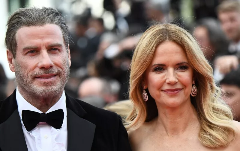 US actor John Travolta and his wife US actress Kelly Preston arrive on May 15, 2018 for the screening of the film "Solo : A Star Wars Story" at the 71st edition of the Cannes Film Festival in Cannes, southern France. (Photo by Anne-Christine POUJOULAT / AFP)