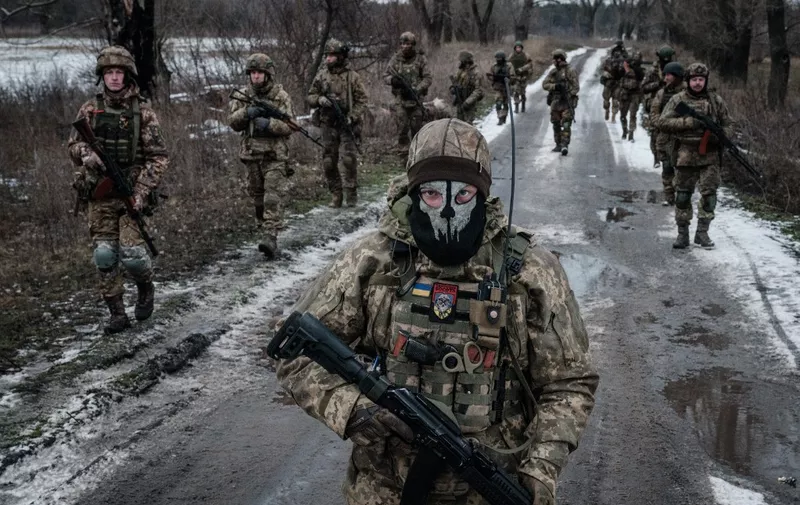 Ukrainian servicemen walk on the road toward their base near the frontline in the Donetsk region on February 4, 2023, amid the Russian invasion of Ukraine. (Photo by YASUYOSHI CHIBA / AFP)