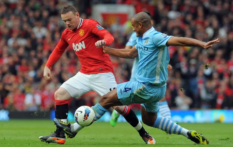 Manchester United's English striker Wayne Rooney (L) vies with Manchester City's Belgian defender Vincent Kompany (R) during the English Premier League football match between Manchester United and Manchester City at Old Trafford in Manchester, north-west England on October 23, 2011. AFP PHOTO/ANDREW YATES

RESTRICTED TO EDITORIAL USE. No use with unauthorized audio, video, data, fixture lists, club/league logos or live services. Online in-match use limited to 45 images, no video emulation. No use in betting, games or single club/league/player publications