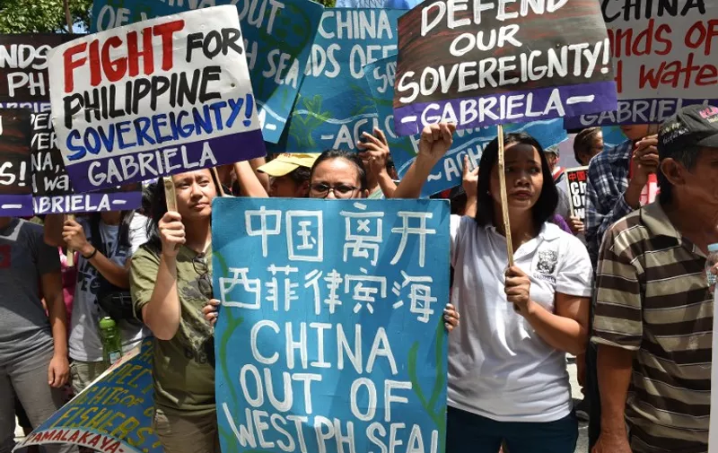 Activists hold placards during a protest in front of the Chinese consulate in Manila on July 12, 2016, ahead of a UN tribunal ruling on the legality of China's claims to an area of the South China sea contested by the Philippines.
Beijing lays claim to virtually all of the South China Sea, putting it at odds with regional neighbours the Philippines, Vietnam, Malaysia, Brunei and Taiwan, which also have partial claims. / AFP PHOTO / TED ALJIBE