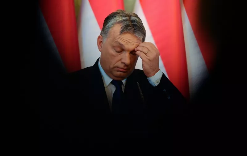 Hungarian Prime Minister Viktor Orban addresses a press conference at the Delegation Hall of the parliament building in Budapest on February 24, 2016.  
Hungary will hold a referendum on whether to accept mandatory EU quotas for migrants, Prime Minister Viktor Orban said, protesting that Brussels has no right to "redraw Europe's cultural and religious identity." / AFP / ATTILA KISBENEDEK