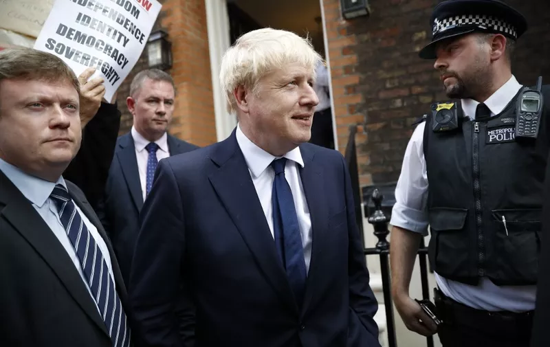 Conservative Party leadership candidate Boris Johnson (C) leaves his campaign offices in Westminster in Central London on July 22, 2019 on the eve of the announcement of the winner of the Conservative Party leadership contest. - Britain's leadership contest entered its finale Monday with the favourite Boris Johnson facing more defections from ministers over his Brexit plan. The month-long contest between former London mayor Johnson and Foreign Secretary Jeremy Hunt is being decided by fewer than 200,000 grassroots members of the governing Conservative Party. The winner will have three months to resolve a three-year Brexit crisis that could damage economies on both sides of the Channel and determine the fate of generations of Britons. (Photo by Tolga AKMEN / AFP)