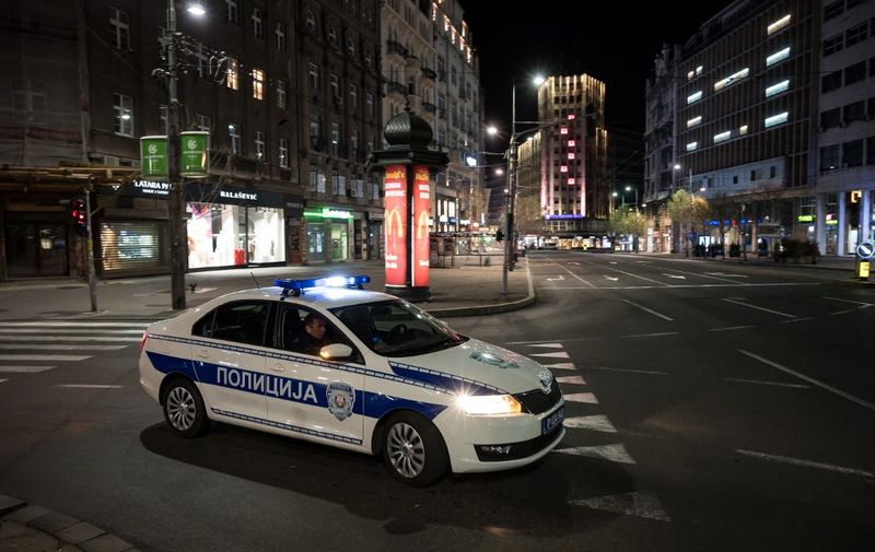 Police officers patrol in downtown Belgrade on March 18, 2020, as Serbia has introduced curfew from 8 pm to 5 am for entire population except those authorised and night shift workers, in a bid to fight the COVID-19 disease caused by the novel coronavirus. (Photo by Andrej ISAKOVIC / AFP)