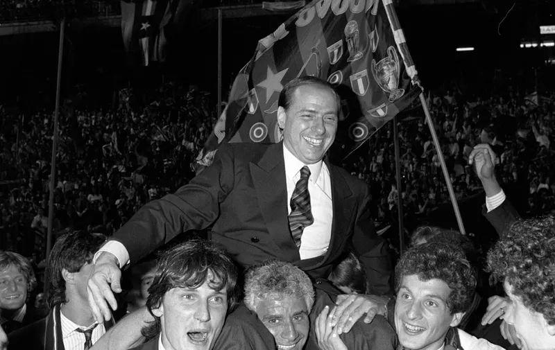 FILE - AC Milan president Silvio Berlusconi is shoulder-carried by Milan players after winning the 1988 Italian championship at the Milan's San Siro stadium. Berlusconi, the boastful billionaire media mogul who was Italy's longest-serving premier despite scandals over his sex-fueled parties and allegations of corruption, died, according to Italian media. He was 86. (AP Photo/Ferdinando Meazza, File)