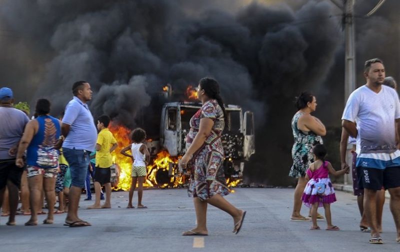 This picture released by O Povo shows a truck burning during a wave of gang violence in Brazil's northeastern Ceara state, in the Conjunto Palmeiras neighborhood, city of Fortaleza, Ceara state, Brazil on January 3, 2019. - Brazil's government ordered troops to the northeast of the country on Friday to contain violence by criminal groups in the first test of new far-right President Jair Bolsonaro's hardline law-and-order platform. (Photo by Alex GOMES / O Povo / AFP) / RESTRICTED TO EDITORIAL USE - MANDATORY CREDIT "AFP PHOTO / O POVO / ALEX GOMES" - NO MARKETING NO ADVERTISING CAMPAIGNS - DISTRIBUTED AS A SERVICE TO CLIENTS