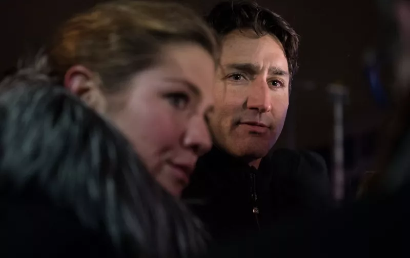 Canadian prime minister Justin Trudeau and his wife Sophie Gregoire lay flowers near the Islamic Cultural Center in Quebec City, Canada on January 30, 2017. - Gunmen stormed into a Quebec mosque during evening prayers January 29 and opened fire on dozens of worshippers, killing six and wounding eight in what Canadian Prime Minister Justin Trudeau condemned as a "terrorist attack." Canadian police sought Monday to piece together the motive for a shooting attack, one of the worst attacks ever to target Muslims in a western country. (Photo by Alice Chiche / AFP)